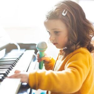 girl-toddler-plays-with-piano Girl toddler plays with piano
