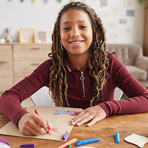 smiling girl drawing