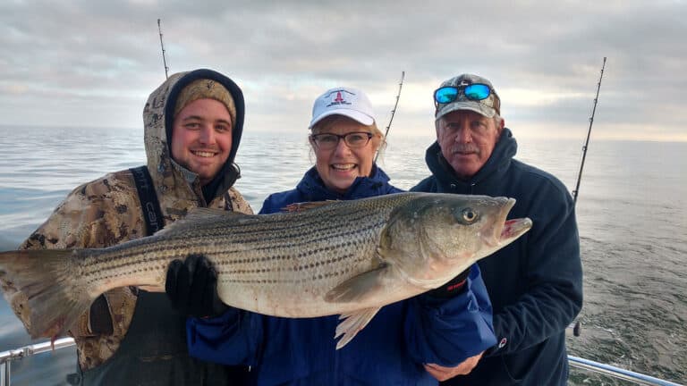 3 anglers holding fish