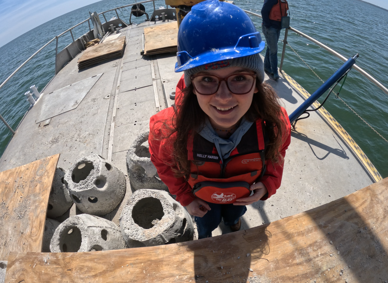 Mollie Rudow prepares a camera to follow reef balls to the bottom